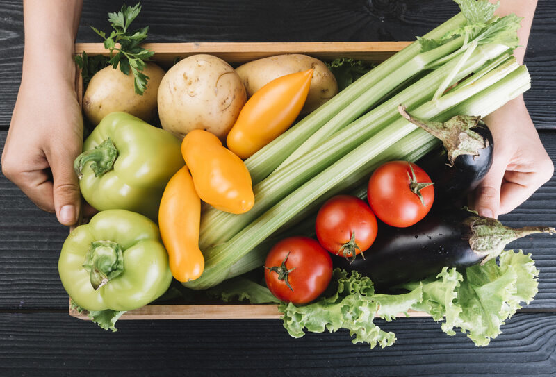 person-holding-container-with-various-fresh-vegetables(1)